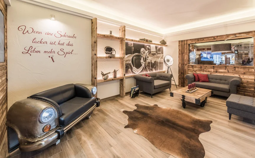 Cozy waiting area with car-themed sofa and wooden decor
