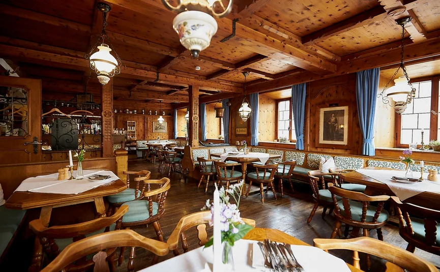 Cozy dining room with wood paneling and traditional style tables