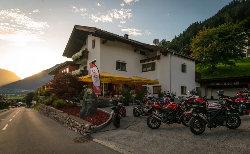 Hotel met motorfietsen geparkeerd bij zonsondergang in de bergen
