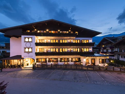 Illuminated hotel building at dusk in the mountains