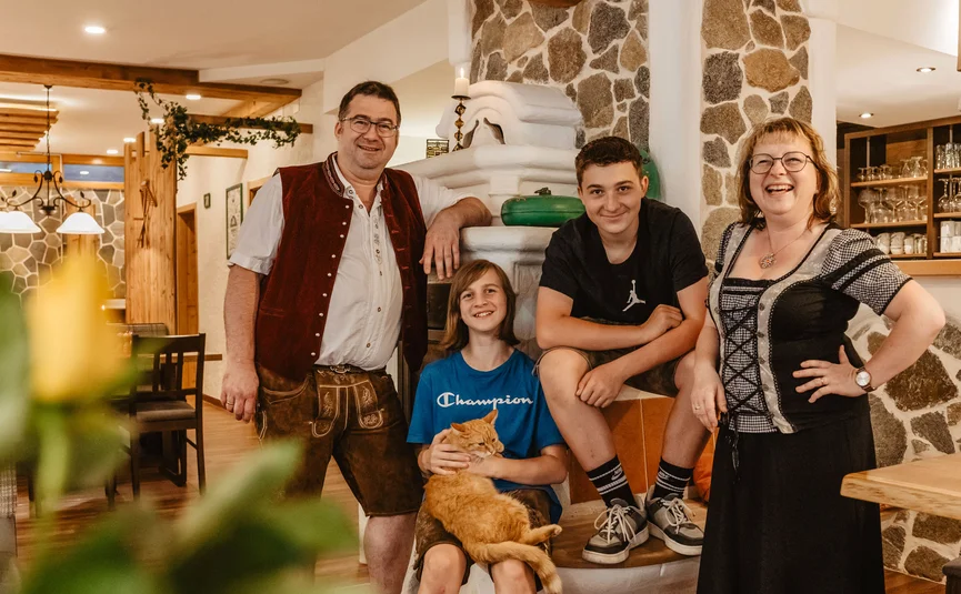 Family with two kids and cat in cozy traditional interior