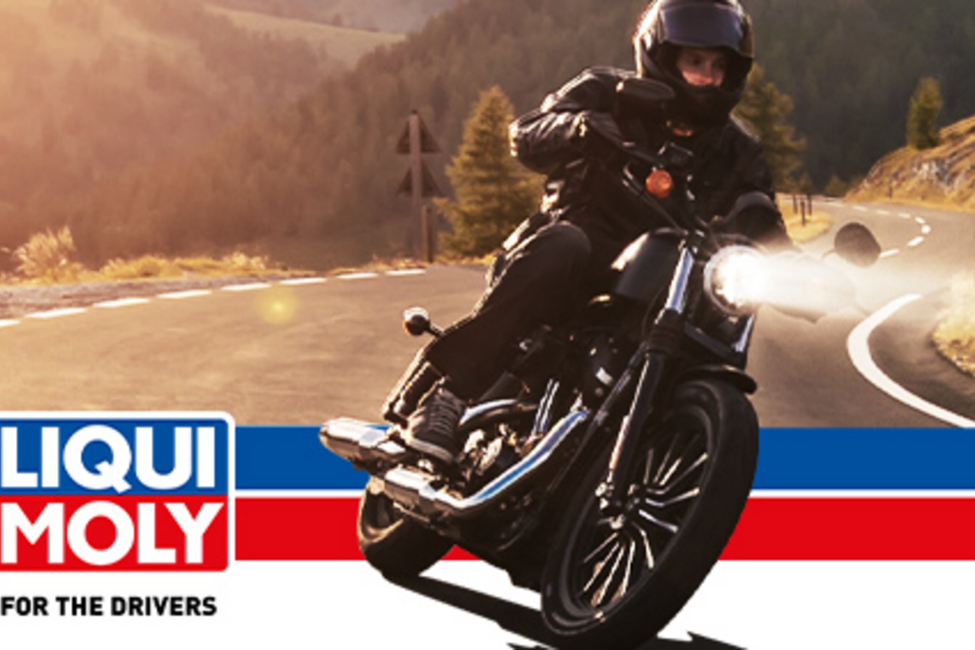 Motorcyclist on winding mountain road with Liqui Moly logo