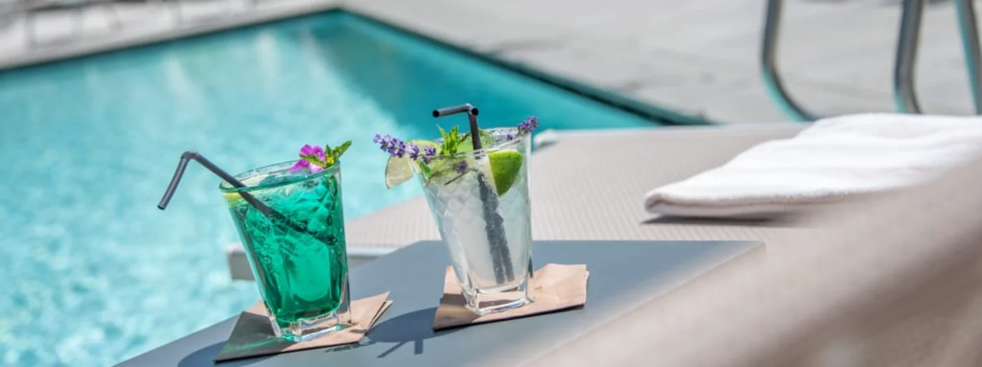 Wellness Weekend 3 Tage Zwei bunte Cocktails auf einem Tisch neben einem Pool