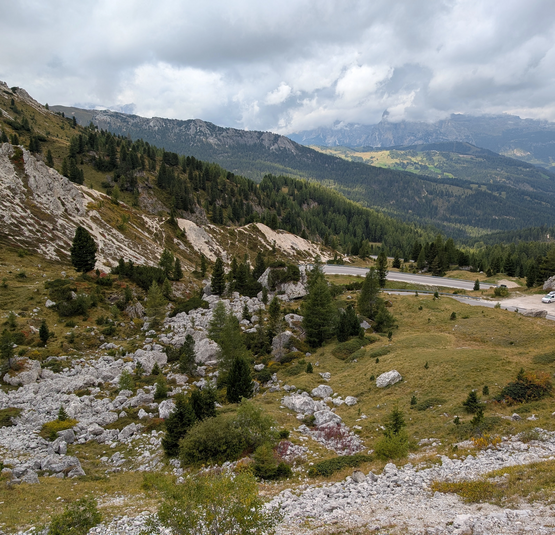 Berglandschap met kronkelende weg en bewolkte lucht