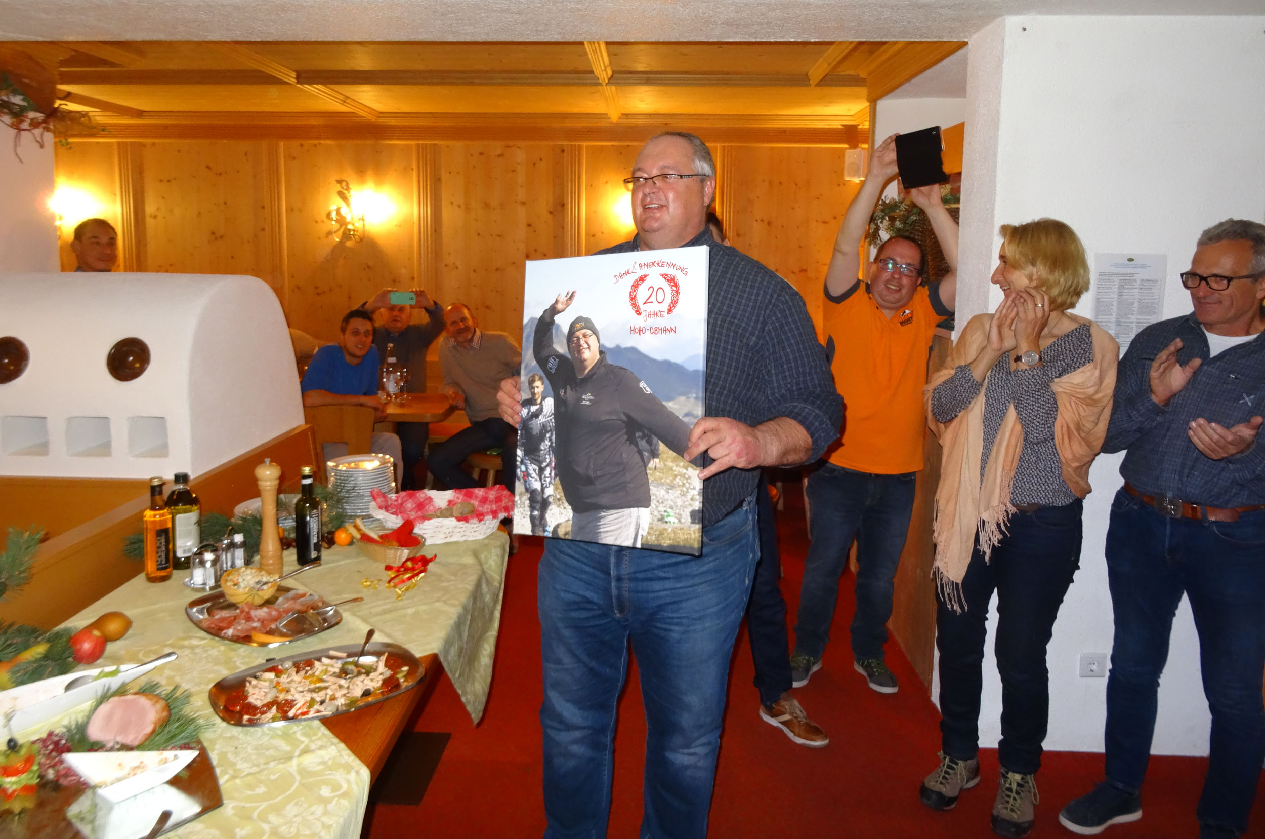 History of the MoHo's Man receives anniversary gift at party, people clapping
