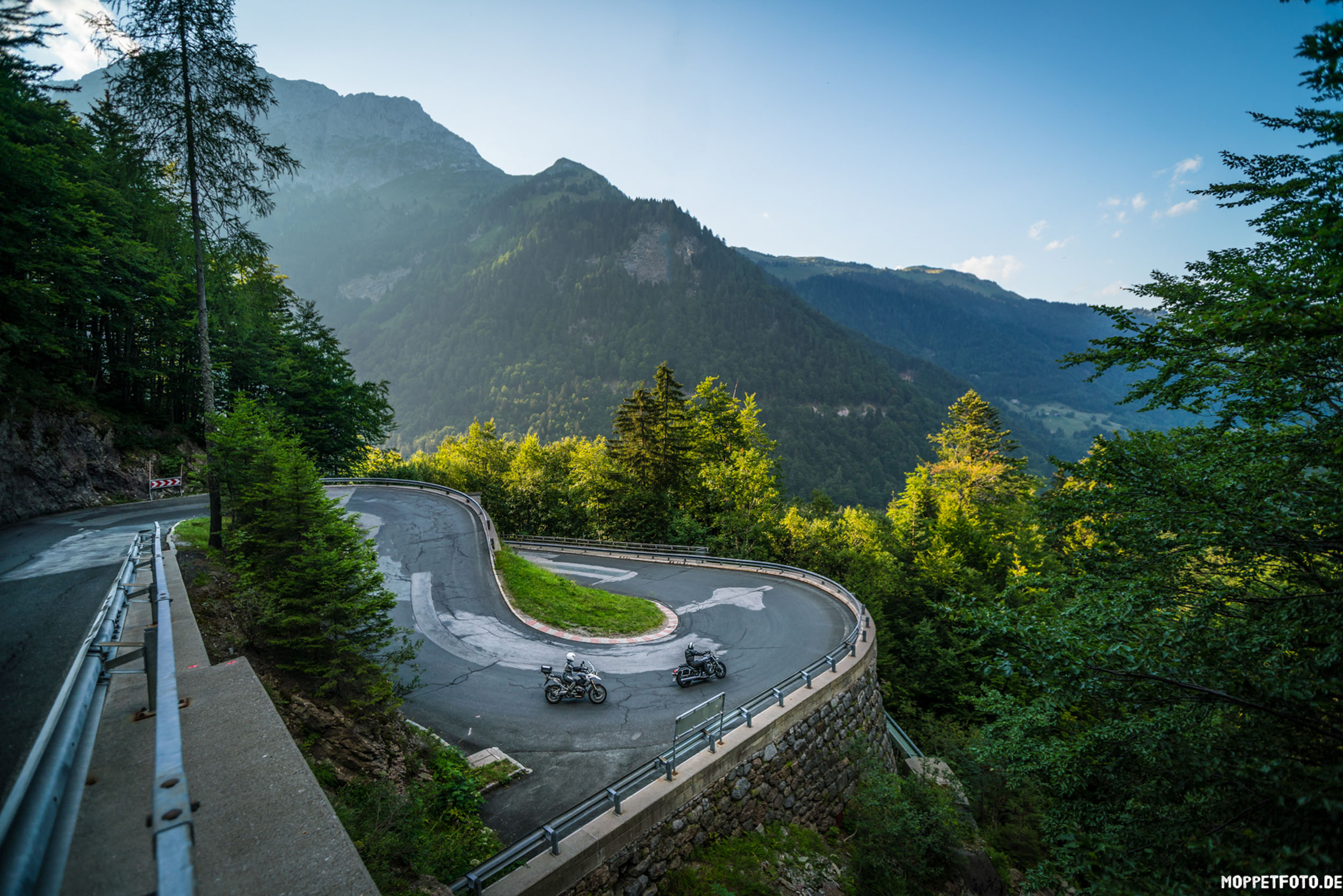 Quality promise © Moppetfoto.de Sharp hairpin mountain road curve with two motorcycles