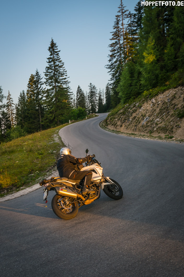 Almhotel & Genussgasthof Hierzegger ***S © Moppetfoto.de Motorcyclist riding a curve on mountain road at sunset