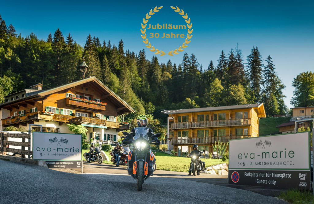 Motorradfahrer verlassen Hotel Eva-Marie vor Waldkulisse, 30-jähriges Jubiläum